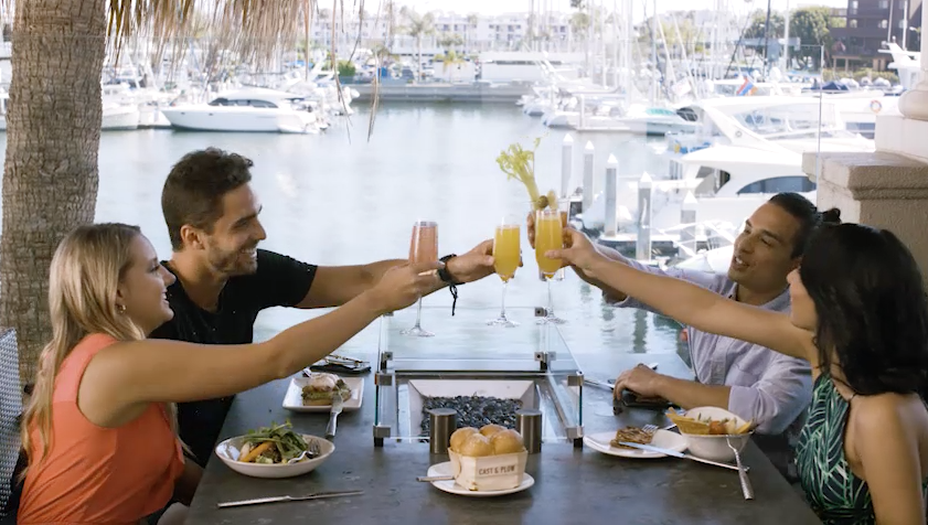 Two couples enjoying mimosas and breakfast